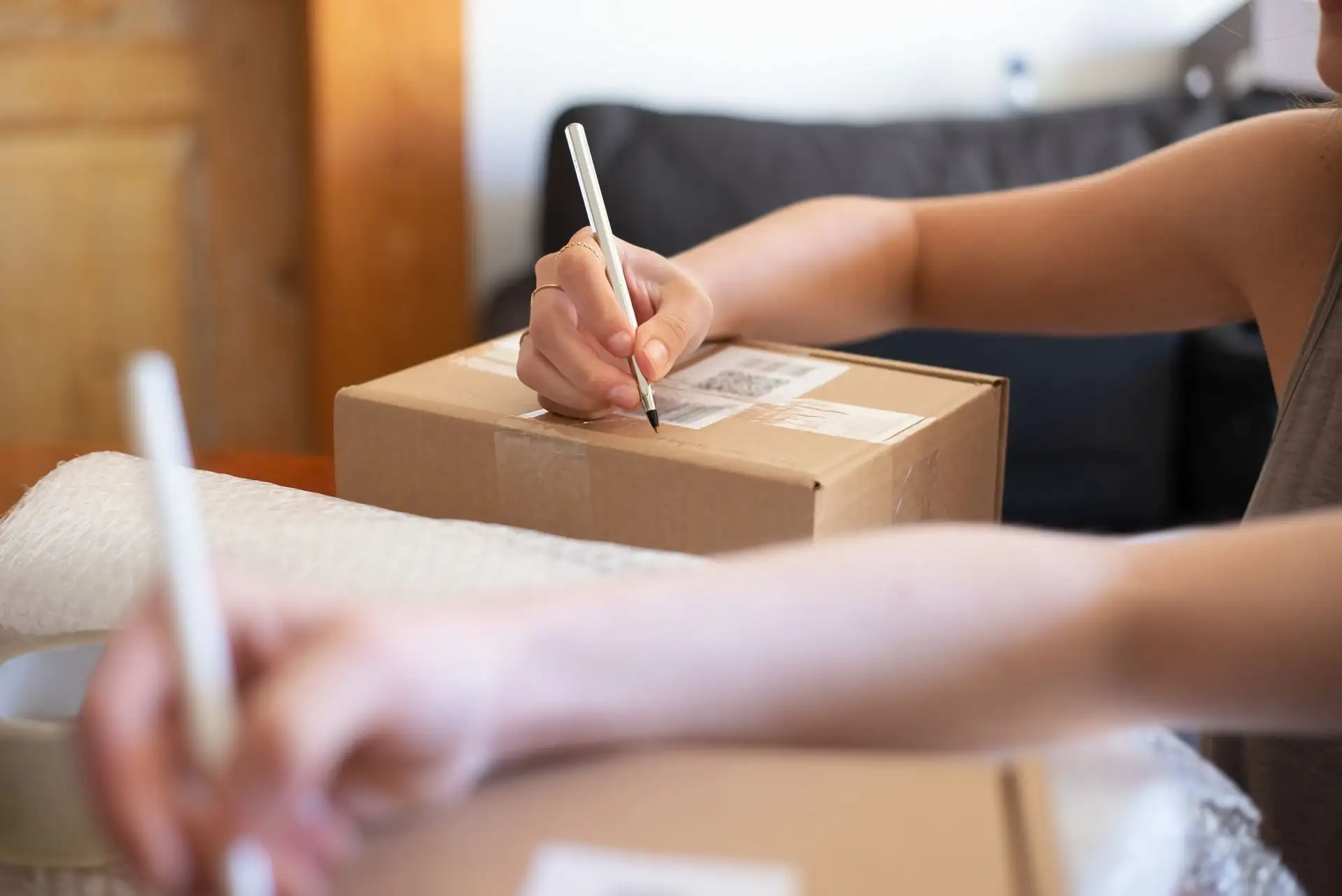 Online seller labelling a parcel for dispatch E P Accountants e-commerce accountants