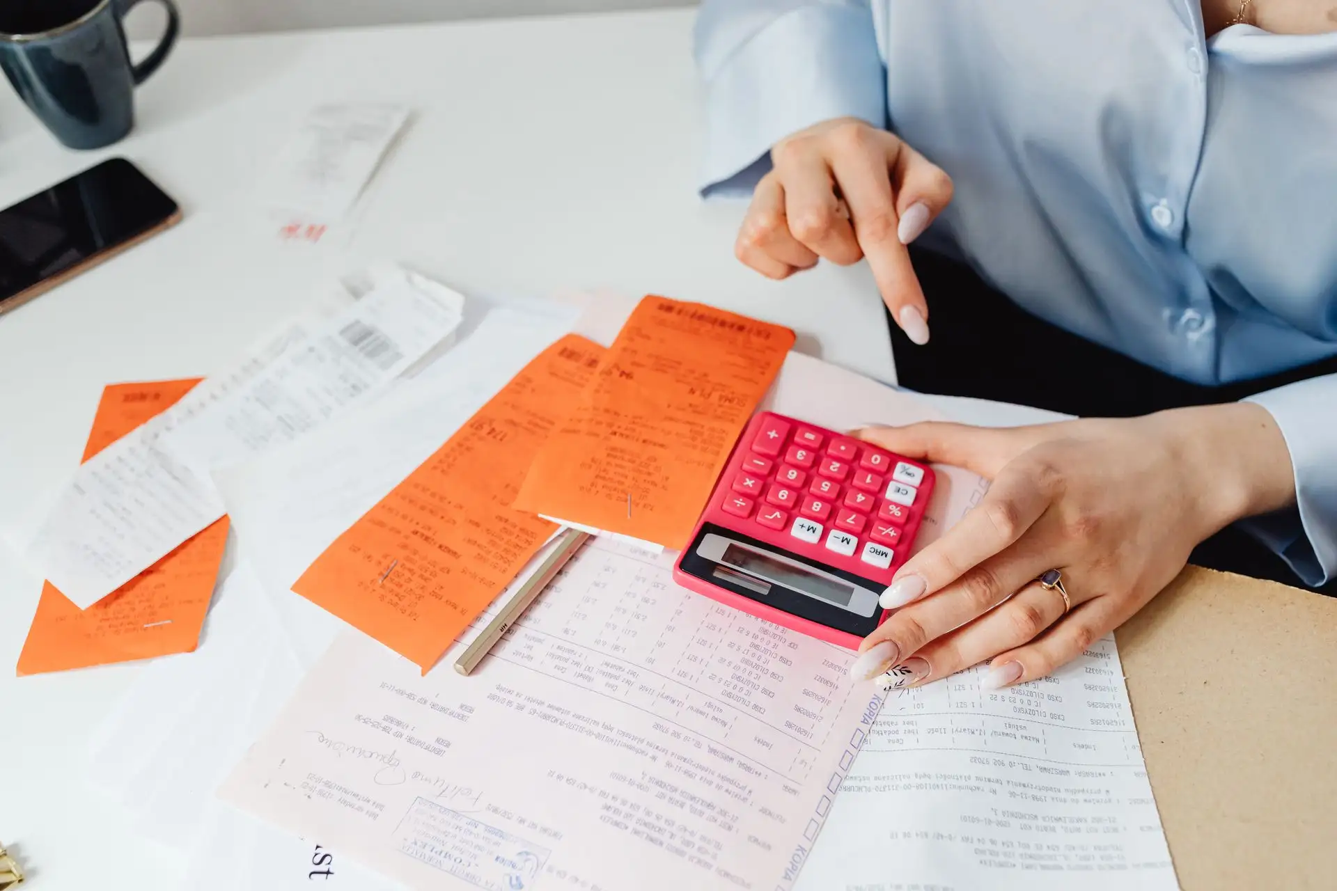 Receipts and calculator being organised for bookkeeping E P Accountants Worcestershire